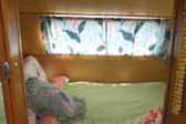 Picture shows cozy bedroom at rear of 1949 Star Vintage Trailer